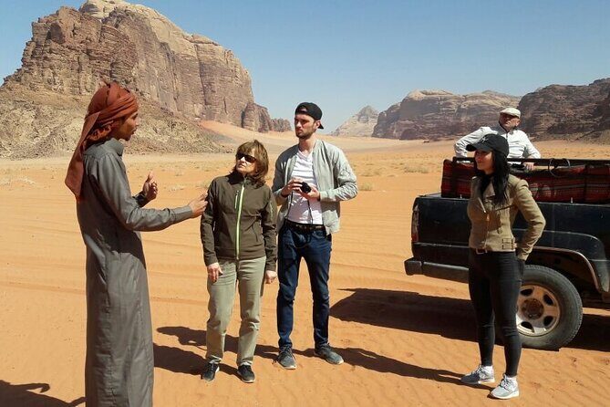 Wadi Rum Short Tours - Um Frouth Arch: scrambling for photos with the sky as your backdrop